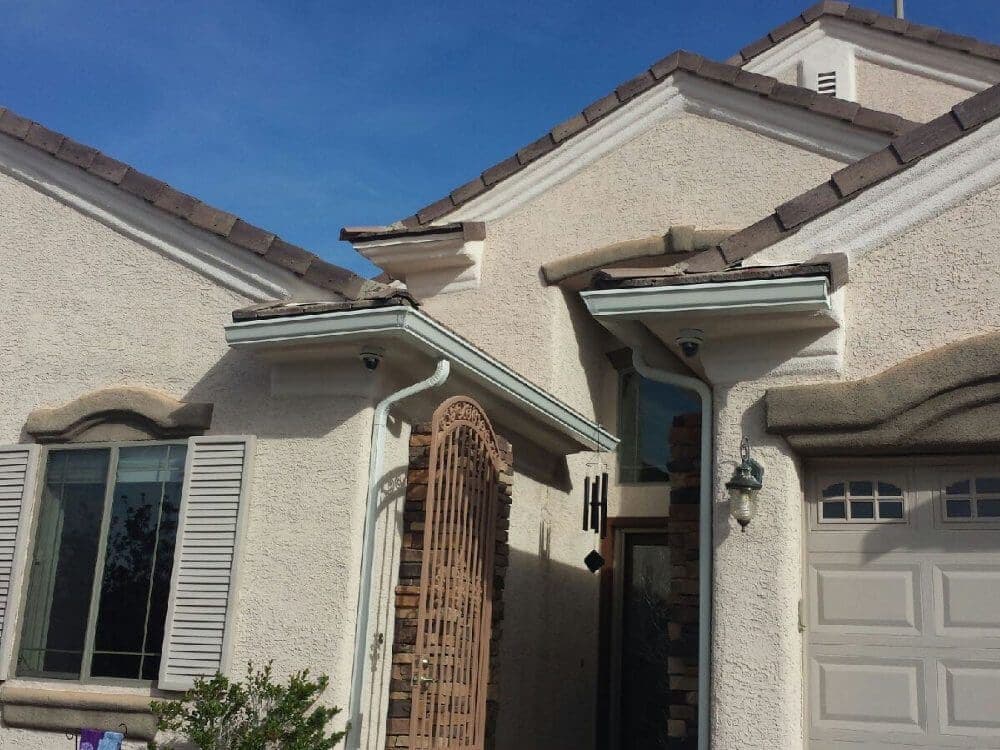 Seamless gutters and downspouts on a two-story home